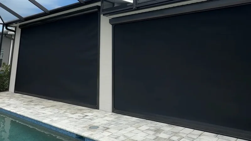 Fully lowered hurricane screens beside a swimming pool