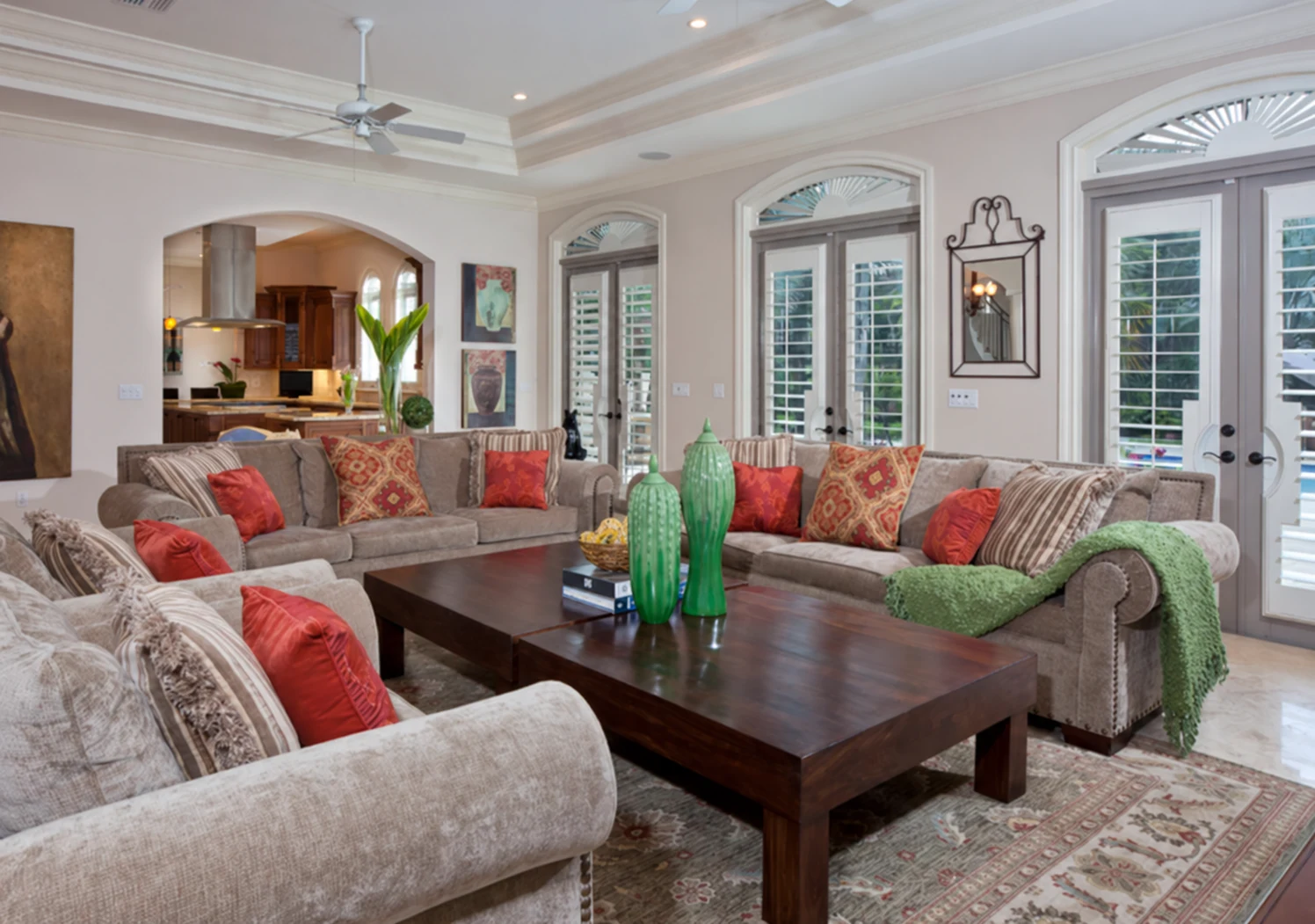 White plantation shutters in arched windows of a living room with Mediterranean architecture